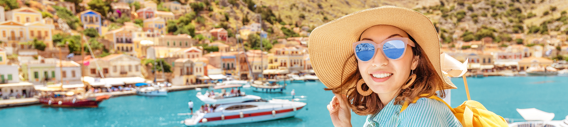 Asian girl traveler with backpack and hat enjoys a sea cruise on a open ship deck. Tourism and vacation in Greece and mediterranean sra. Transport and travel inspiration